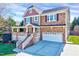 Charming two-story home featuring a brick and siding exterior, attached two-car garage, and inviting front porch at 105 Presley Snow Ct, Holly Springs, NC 27540