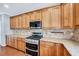 Charming kitchen with granite countertops, stainless appliances, and custom cabinetry at 105 Presley Snow Ct, Holly Springs, NC 27540