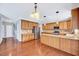 Spacious open kitchen featuring granite counters, stainless appliances, and ample wood cabinets at 105 Presley Snow Ct, Holly Springs, NC 27540
