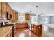 Well-equipped kitchen with wood cabinets, granite countertops, and stainless steel appliances at 105 Presley Snow Ct, Holly Springs, NC 27540