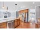 Open kitchen layout with stainless steel appliances and granite countertop island at 105 Presley Snow Ct, Holly Springs, NC 27540