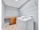 Functional laundry room featuring shelving and modern washer and dryer at 105 Presley Snow Ct, Holly Springs, NC 27540