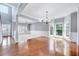 Open-concept living room featuring hardwood floors and plenty of natural light at 105 Presley Snow Ct, Holly Springs, NC 27540