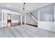 Bright and airy living room with neutral carpeting, and open access to dining area with gleaming wood floors at 105 Presley Snow Ct, Holly Springs, NC 27540