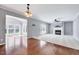 Open-concept living space with hardwood flooring transitioning to carpet near the fireplace at 105 Presley Snow Ct, Holly Springs, NC 27540