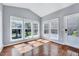 Bright sunroom with hardwood floors, large windows and deck access at 105 Presley Snow Ct, Holly Springs, NC 27540
