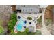Aerial shot of a property showcasing its private pool, patio area, and meticulously landscaped yard at 106 Woodkirk Ln, Chapel Hill, NC 27514