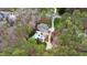 Aerial view of a secluded property with a pool, patio, long driveway, and forest surrounding the home at 106 Woodkirk Ln, Chapel Hill, NC 27514