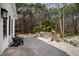 An inviting outdoor living space featuring a built-in grill, stone accents, and comfortable seating at 106 Woodkirk Ln, Chapel Hill, NC 27514
