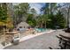 A luxurious outdoor space with a pool, cabana, built-in grill, and lush landscaping for ultimate relaxation at 106 Woodkirk Ln, Chapel Hill, NC 27514