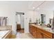 Bright bathroom featuring double sinks, granite countertops, and a linen closet at 106 Woodkirk Ln, Chapel Hill, NC 27514