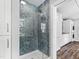 Stylish bathroom featuring a glass-enclosed shower with blue mosaic tiles, creating a spa-like retreat at 106 Woodkirk Ln, Chapel Hill, NC 27514
