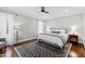 Comfortable bedroom with large windows, soft carpet, and a decorative ceiling fan at 106 Woodkirk Ln, Chapel Hill, NC 27514