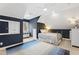Well lit bedroom with dark blue accent walls, a light blue rug, and sloped ceilings at 106 Woodkirk Ln, Chapel Hill, NC 27514