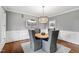 Elegant dining room features wainscoting and a contemporary chandelier, perfect for gatherings at 106 Woodkirk Ln, Chapel Hill, NC 27514