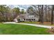 Spacious home with an expansive front lawn and a long driveway leading to a well-maintained property at 106 Woodkirk Ln, Chapel Hill, NC 27514