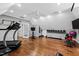 Home gym featuring wood floors, a ceiling fan, weights, and varied workout equipment at 106 Woodkirk Ln, Chapel Hill, NC 27514