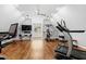 Spacious home gym with wood floors, varied workout equipment, and natural light at 106 Woodkirk Ln, Chapel Hill, NC 27514