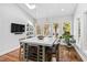 Bright eat-in kitchen featuring an island with wine cooler and views of the outdoor greenery at 106 Woodkirk Ln, Chapel Hill, NC 27514