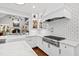 Modern kitchen features subway tile backsplash, white cabinetry, and stainless steel appliances, including a large gas range at 106 Woodkirk Ln, Chapel Hill, NC 27514