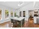 Open concept kitchen with an island, skylight, and adjacent views of the living room and pool at 106 Woodkirk Ln, Chapel Hill, NC 27514