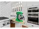Elegant kitchen with stainless appliances, white cabinets, subway tile, and marble countertops, including convenient mixer shelf at 106 Woodkirk Ln, Chapel Hill, NC 27514