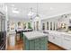 Gourmet kitchen with marble countertops, skylights, stainless steel appliances, and an adjacent dining area with backyard views at 106 Woodkirk Ln, Chapel Hill, NC 27514
