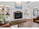 Living room showcasing a stone fireplace with white mantel and a display of art and built-in bookcases at 106 Woodkirk Ln, Chapel Hill, NC 27514