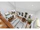 Aerial view of an open living area with high ceilings, a fireplace, and a view of the kitchen at 106 Woodkirk Ln, Chapel Hill, NC 27514