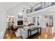 Open-concept living area with fireplace, built-in bookshelves, and second story view at 106 Woodkirk Ln, Chapel Hill, NC 27514