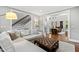Inviting living room with hardwood floors, staircase access, and an open view into the main living room at 106 Woodkirk Ln, Chapel Hill, NC 27514