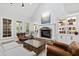 Stylish living room featuring stone fireplace, built-in bookcases, and comfortable seating arrangement at 106 Woodkirk Ln, Chapel Hill, NC 27514