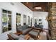 Inviting sunroom featuring a stone fireplace, ample seating, and bright, natural light at 106 Woodkirk Ln, Chapel Hill, NC 27514