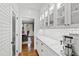 Pantry features white subway tile backsplash, marble countertop, glass-front cabinets, and hardwood floors at 106 Woodkirk Ln, Chapel Hill, NC 27514
