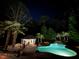 Stunning outdoor pool area with a charming cabana and lush landscaping, perfect for evening relaxation and entertaining at 106 Woodkirk Ln, Chapel Hill, NC 27514