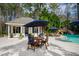 Charming poolside retreat featuring a cabana, outdoor dining, and a water slide, perfect for entertaining at 106 Woodkirk Ln, Chapel Hill, NC 27514
