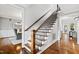 Hardwood staircase features decorative iron spindles and leads to other rooms in the house at 106 Woodkirk Ln, Chapel Hill, NC 27514