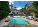 A luxurious swimming pool with poolside lounge seating and manicured landscaping, perfect for relaxation and recreation at 106 Woodkirk Ln, Chapel Hill, NC 27514