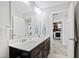 Bathroom featuring double sink vanity with marble countertop with doorways to a toilet area and laundry room at 1213 Valley Dale Dr, Fuquay Varina, NC 27526