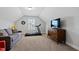 Bonus room featuring a couch, treadmill, and media console creates a versatile living space at 1213 Valley Dale Dr, Fuquay Varina, NC 27526