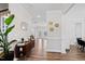 Elegant foyer featuring hardwood floors, a console table with plants, and decor, flowing into an open living space at 1213 Valley Dale Dr, Fuquay Varina, NC 27526