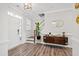 Welcoming foyer with hardwood floors, a staircase, and a stylish console table with decorative accents at 1213 Valley Dale Dr, Fuquay Varina, NC 27526