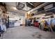 Organized garage featuring overhead storage racks, cabinets and two refrigerators at 1213 Valley Dale Dr, Fuquay Varina, NC 27526