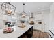 Well-lit kitchen with a large island, stainless steel appliances, white cabinets, and stylish pendant lights at 1213 Valley Dale Dr, Fuquay Varina, NC 27526