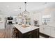 Modern kitchen featuring a large island with seating and stylish lighting fixtures at 1213 Valley Dale Dr, Fuquay Varina, NC 27526