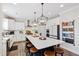 Bright and airy kitchen with a large center island, white cabinets, pendant lighting, and stainless steel appliances at 1213 Valley Dale Dr, Fuquay Varina, NC 27526