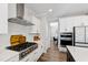 Bright kitchen with stainless steel gas range, white cabinets, and a center island, adjacent to the dining area at 1213 Valley Dale Dr, Fuquay Varina, NC 27526