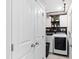 A functional laundry room with shelving and modern appliances at 1213 Valley Dale Dr, Fuquay Varina, NC 27526