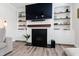 Living room featuring fireplace, built-in shelving, and neutral colors at 1213 Valley Dale Dr, Fuquay Varina, NC 27526