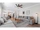 Cozy living room with a large sectional sofa, ceiling fan, and modern decor at 1213 Valley Dale Dr, Fuquay Varina, NC 27526